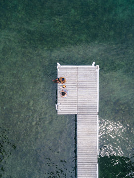 Woman cutting stone fruit on the dock