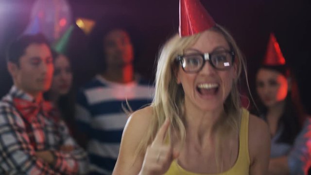  Nerdy girl standing out from the crowd with geeky dancing at house party