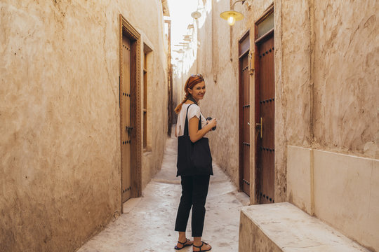 Female photographer taking photos in a small passage