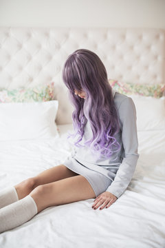 Fashionable young woman with purple hair