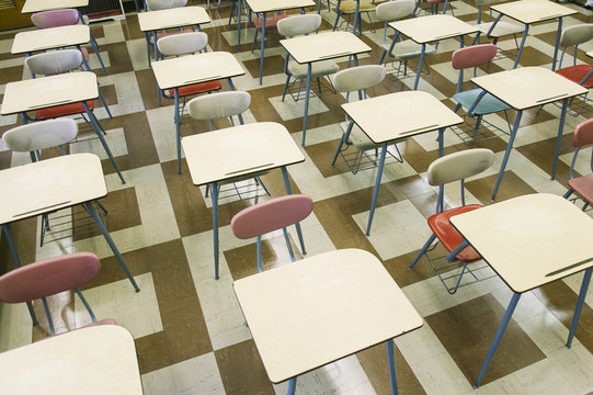Empty chairs and tables in classroom of elementary school