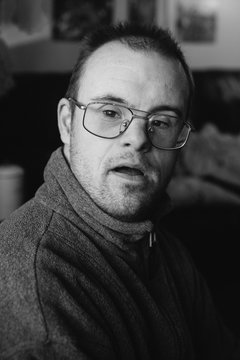 Black and white portrait of a middle aged man with special needs.
