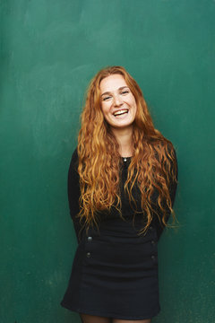 Portrait of red-haired woman smiling at camera