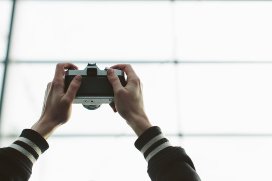 Two Arms Holding Camera Up In The Air