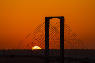 SEVILLE, SPAIN - AUGUST 21, 2017: Fifth Centenary Bridge with partial eclipse sunset
