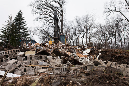 Heavy machinery used to demo a house