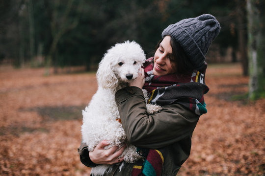 Beautiful woman having a good time with her dog outdoors