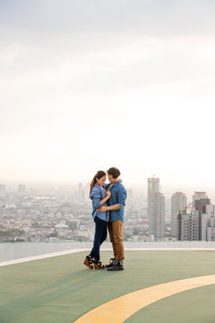 Couple in love hugging on helipad