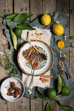 Lemons, limes and several species on a hand-painted spanish ceramics on a worn wood surface