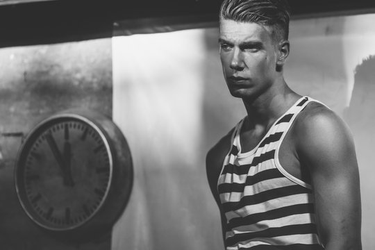 time, clock, past , handsome fashionable young man in a striped shirt