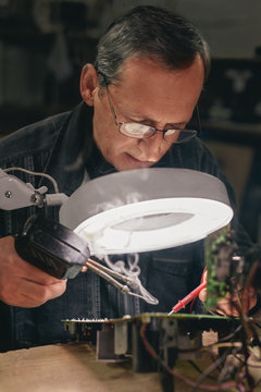 Technician soldering  circuits