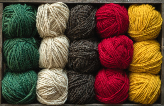 Colorful yarn balls in crate
