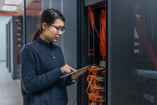 Female technician working in data center