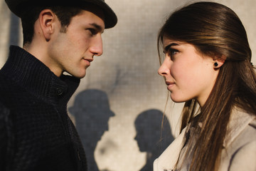 Young man and young woman looking in opposite directions