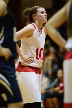 female basketball player stands at foul line during basketball game