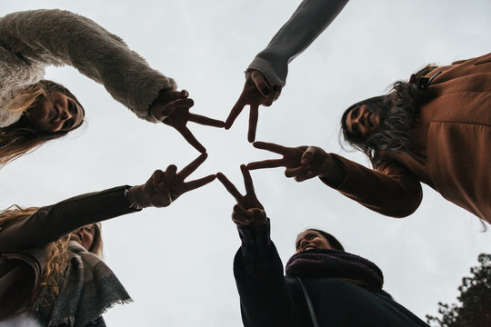 Friends Doing a Star Shape with Fingers