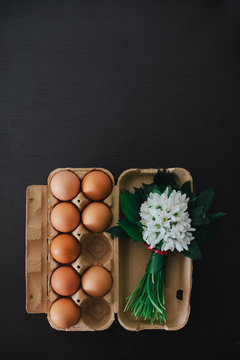 Eggs and a bouqueut of snowdrops on a table