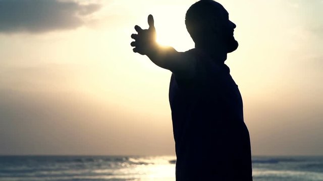 Happy man turning around near sea during sunset, super slow motion 120fps
