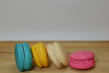 colorful macaroon on wood board white background or text space