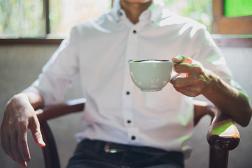 Close-up of young man holding coffee