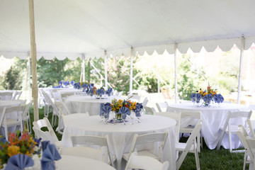 Wildflower Wedding Centerpieces with Black Eyed Susans, Snapdragons, and Delphinium on a Reception Table with White Tablecloth