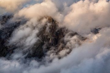 Beautiful artistic render of a rocky mountain peak covered by the clouds. Picture taken in Garibaldi, near Squamish, BC, Canada.