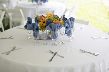 Wildflower Wedding Centerpieces with Black Eyed Susans, Snapdragons, and Delphinium on a Reception Table with White Tablecloth