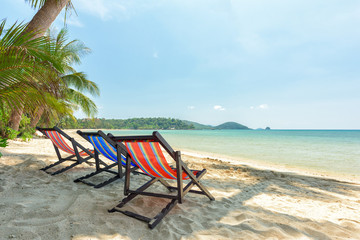 Beach chairs on the white sand beach and tropical sea
