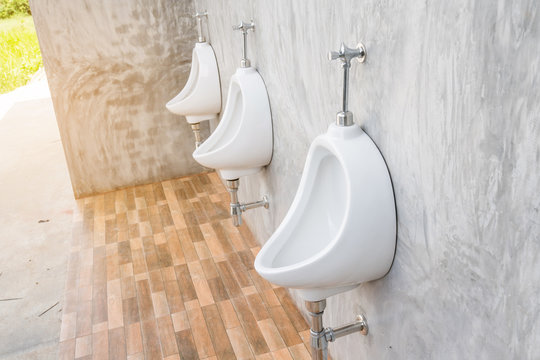 white urinal  On The Concrete Wall