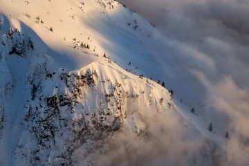 Abstract Aerial View on the top of the snow covered mountain ridge. Picture taken North of Vancouver near Howe Sound, British Columbia, Canada.
