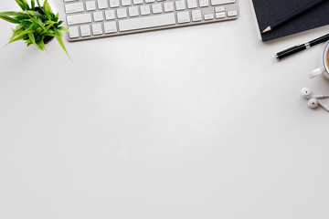 Stylish minimalistic workplace with keyboard, notebook, office plant, notebook, glasses in flat lay...