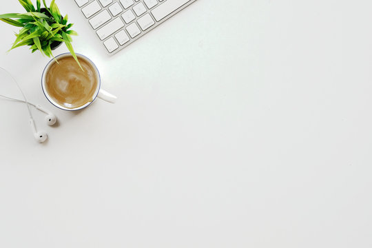 Stylish Minimalistic Workplace With Keyboard, Office Plant And Coffee In Flat Lay Style. White Background. Top View.