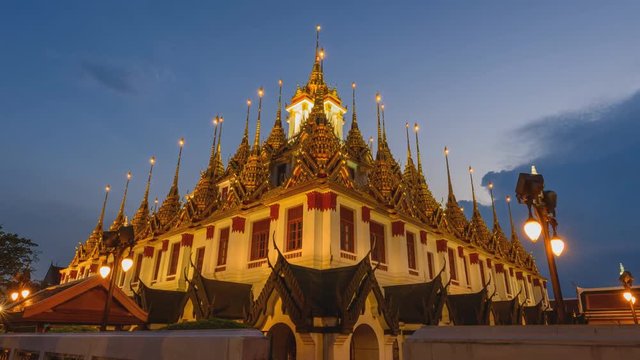 Day to night zoom in time lapse of Golden pagoda in Wat Ratcha Nadda Temple / public temple landmark