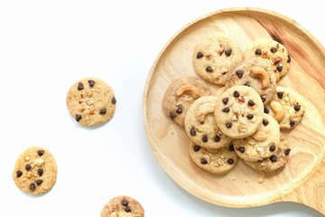 Top view, cookies on wooden plate with white background