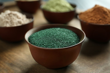 Spirulina powder in bowl on table