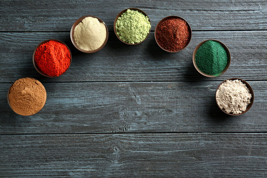 Different Colorful Superfood Powders In Bowls On Wooden Table