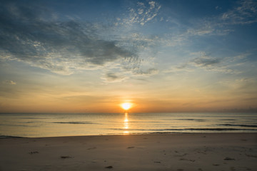 At a beach in Hua Hin city, Thailand. Sunrise over the sea, Calm ocean with Colorful dawn over the sea.