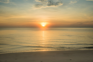 At a beach in Hua Hin city, Thailand. Sunrise over the sea, Calm ocean with Colorful dawn over the sea.