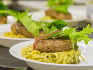 Many hamburg steak serve with noodle and vegetable