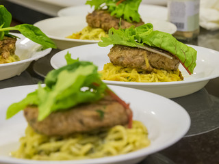 Many hamburg steak serve with noodle and vegetable