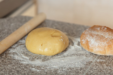 Fototapeta na wymiar kneading dough and bread in flour on table