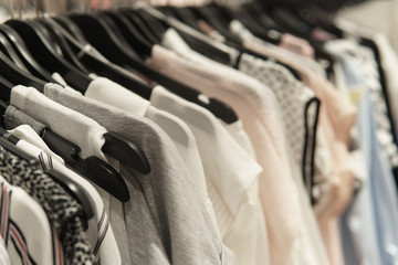 Colorful clothes on hangers at shopping mall