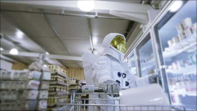  Off duty astronaut walking through supermarket, shopping for groceries