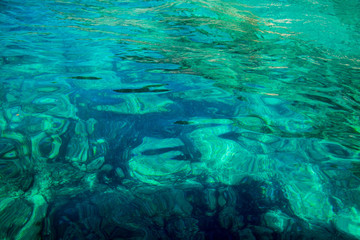  turquoise green transparent water  in a bright summer day