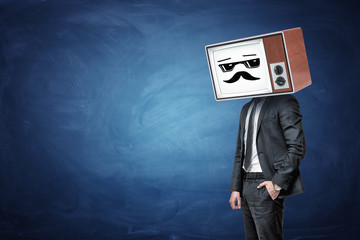 A businessman has one in a pocket and wears an old TV instead of his head, while it shows a white cool guy emoticon.