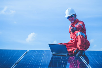 engineer checking job routine of labor working on cleaning solar panel at outside ; operation working on preventive and maintenance in solar power plant for great efficiency