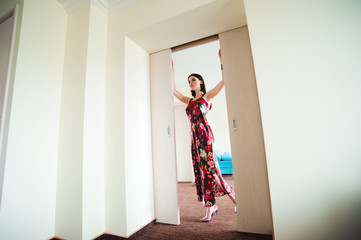 Young woman opening door at modern hotel room
