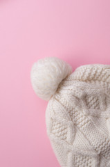 white knitted hat on pink background