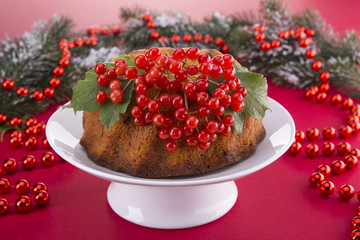 Christmas pudding with a viburnum on a festive table