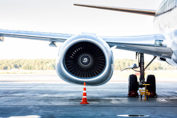 Close-up of engine and main landing gear of passenger airplane
